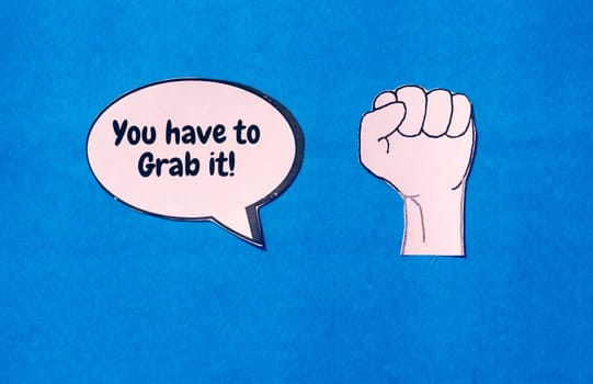 Firm human hand with motivation text on speech bubble isolated on blue background. Conceptual image shows strength protest power and revolution.