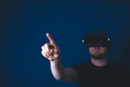 Metaverse digital cyber world technology. Man with VR glasses using AR augmented reality entertainment. NFT, game, futuristic lifestyle.