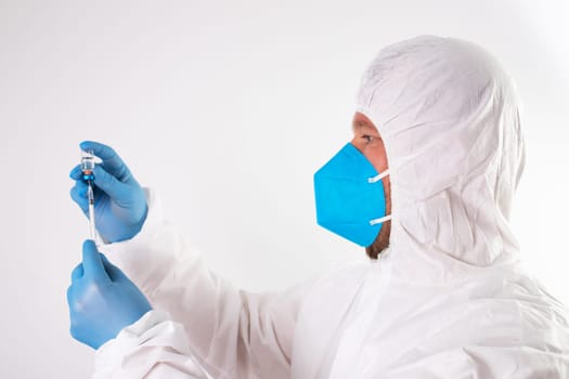 COVID-19 coronavirus vaccine. Vaccination concept. Doctor's hand in blue gloves hold medicine vaccine vial bottle and syringe.