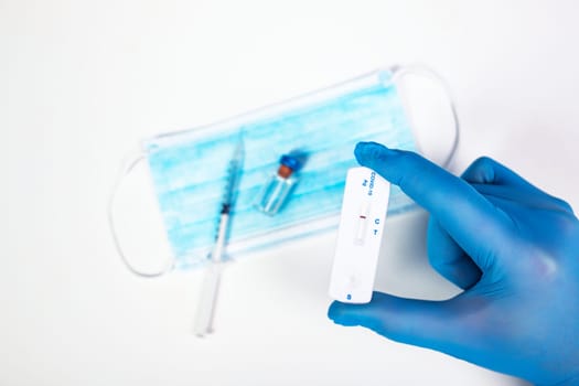 Flat lay of vaccine, test and medical mask. The concept of prevention during Coronavirus pandemic.