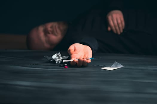 Drug addict reaches for another dose of drug. Concept of addiction, antidrug. International Day against Drug Abuse.