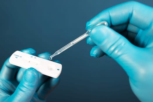 Medical healthcare holding COVID-19, coronavirus swab collection kit, wearing protective gloves