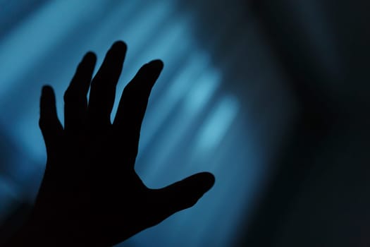 Dark hand shadow reaching into the unknown