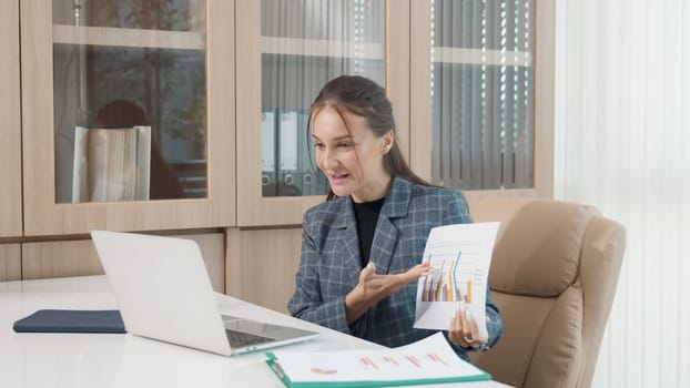 Happy business woman presenting report charts and finance graphs on video call online with laptop computer, woman boss call conference meeting with team, financial and investment concept