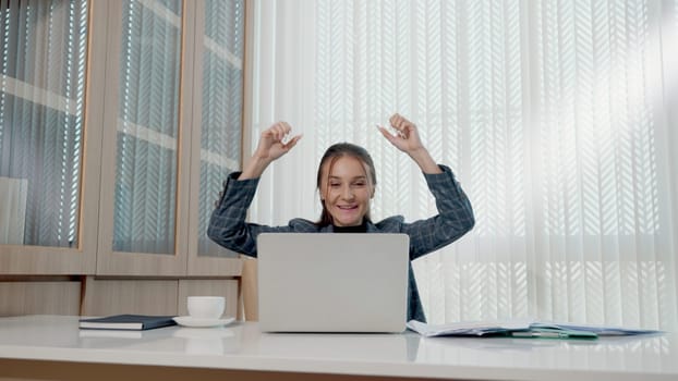 Happy business woman excited surprised work at white office desk with pc laptop throwing up paper account documents, woman boss throw papers fly in air she success work project