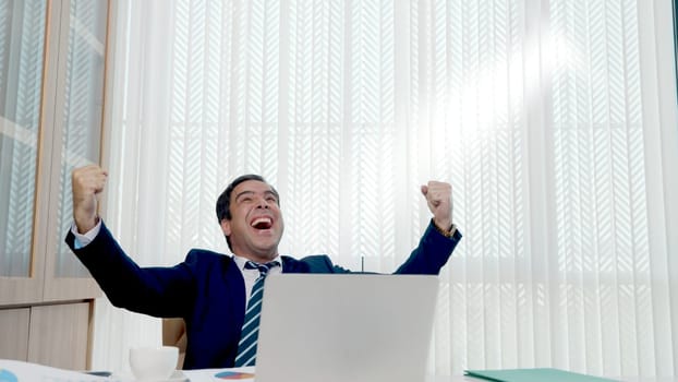Happy business man excited surprised work at white office desk with pc laptop throwing up paper account documents, The man boss throw papers fly in air she success work project