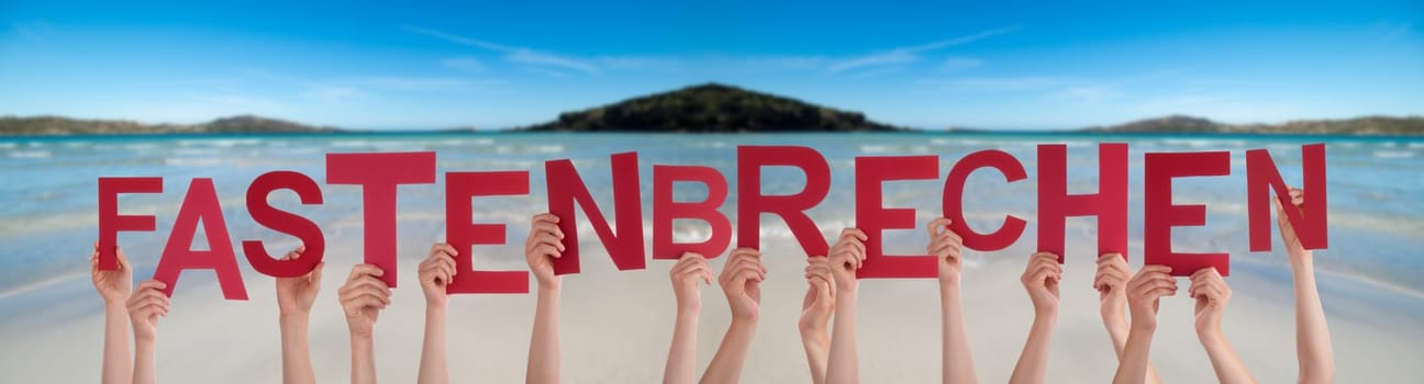 People Hands Holding Red German Word Fastenbrechen Means Fast-Breaking. Ocean And Beach As Background