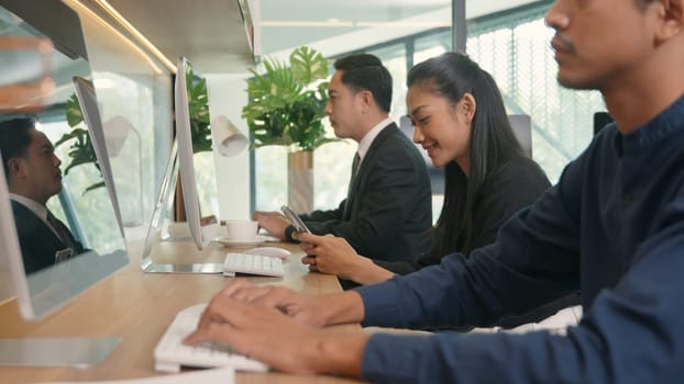 Businesswoman using smartphones on workspace desk in office during team working on computer, Business people holding mobile devices communication technology social network during work time