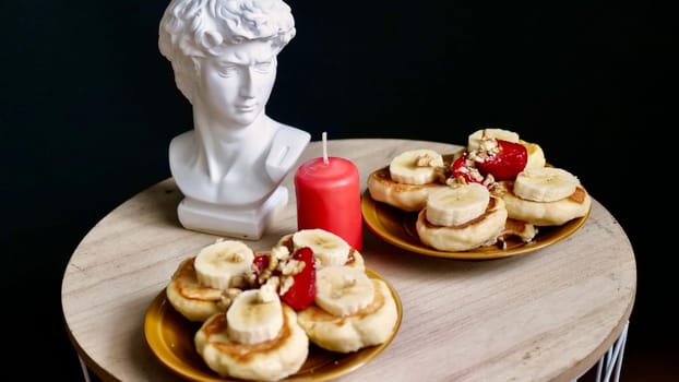 Festive healthy breakfast on a special day, honeymoon, Valentine's Day, Birthday, March 8. Food, cheesecakes with banana and nuts and a table