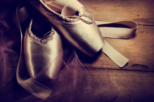 Pointe shoes on wooden background