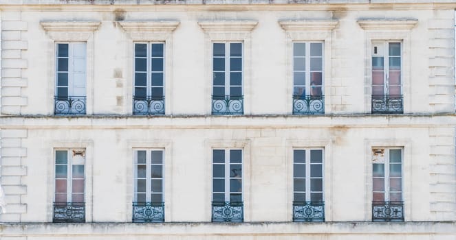 Architectural building with windows and railings o Rochefort in France