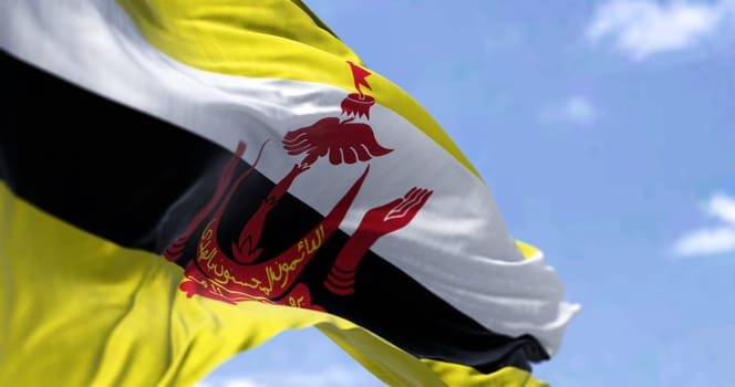 Detail of the national flag of Brunei waving in the wind on a clear day. Democracy and politics. Patriotism. Selective focus. South east Asian country.