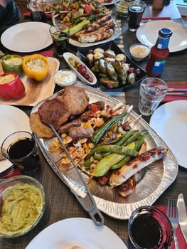 Beef steak with grilled vegetables and seasoning on serving board