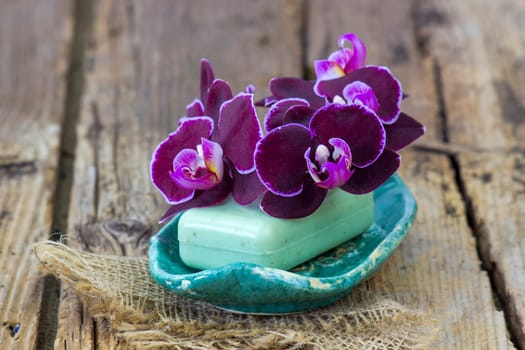 bar of natural soap and orchid flower