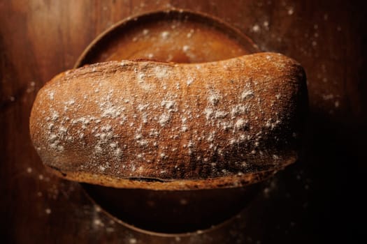 freshly baked bread on wooden table with loaf details