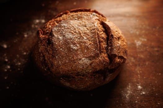 freshly baked bread on wooden table with loaf details