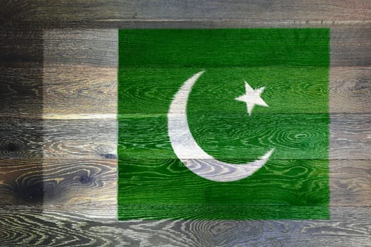 A Pakistan flag on rustic old wood surface background