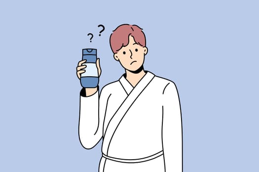 Cosmetics and treatments for men concept. Young man wearing bathtub standing cosmetic bottle in hands with question mark nearby vector illustration