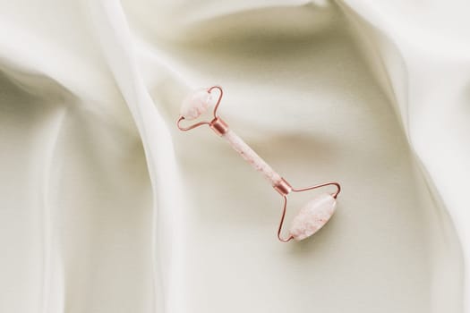 Quartz beauty face roller on white silk 3D rendering