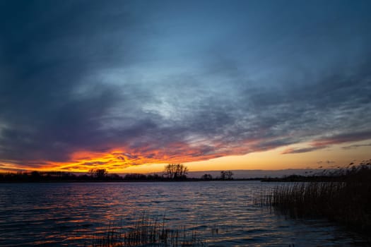 Colorful clouds after sunset on the lake, Stankow, Lubelskie, Poland