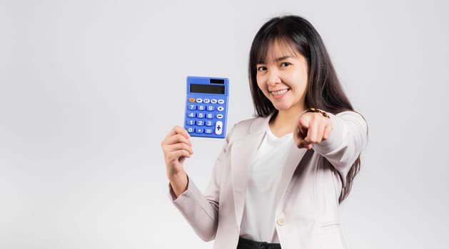 Tax day concept. Woman confident smiling holding calculator and finger point to camera, Portrait excited happy Asian female studio shot isolated on white background, It's time to calculate your taxes