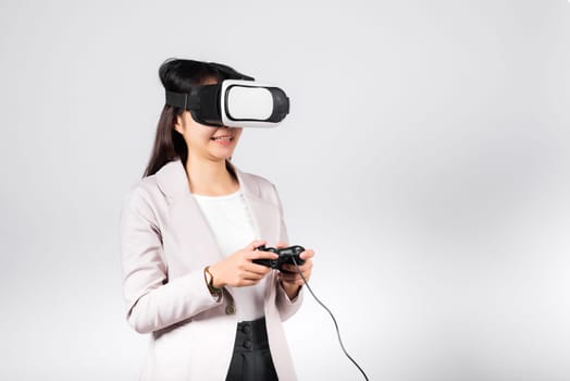 Smile woman confidence excited wear 3D VR headset device and playing game virtual reality experience with joystick isolated white background, Asian happy female play video game studio shot,copy space
