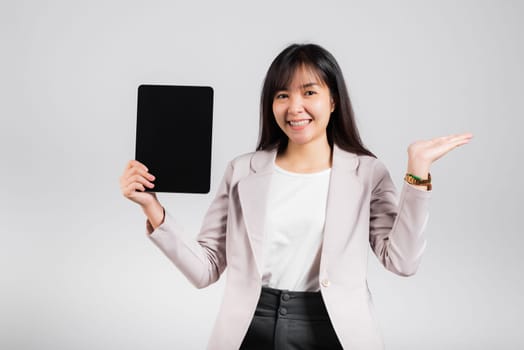Asian beautiful young woman smiling using tablet computer, Happy female show blank screen digital tablet pc and presenting product with palm of hand at empty, studio shot isolated on white background