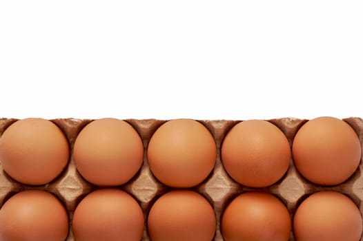A dozen eggs on a cardboard stand on a white isolated background, copy space. High quality photo