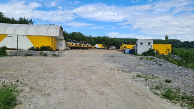 A large quarry dump truck in a coal mine. Loading coal into body trucks. Mining equipment for the transportation of minerals.