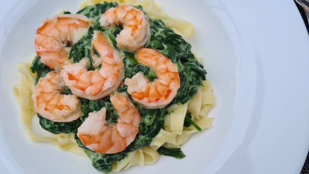 Shrimp Fetticcin Pasta. Italian pasta with shrimp and cream Alfredo sauce, top view, copy space.
