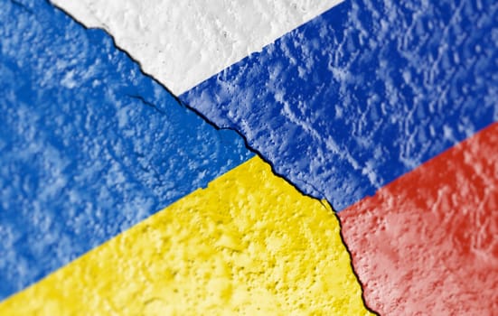 the flags of Ukraine and Russia painted on a ruined wall and divided by a diagonal crack. International diplomatic relations.