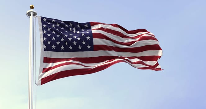 The national flag of the United States of America waving in the wind. Clear sky in the background. Democracy, independence and election day. Patriotic symbol of American pride