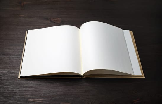 Blank brochure or book mock up on wood table background.