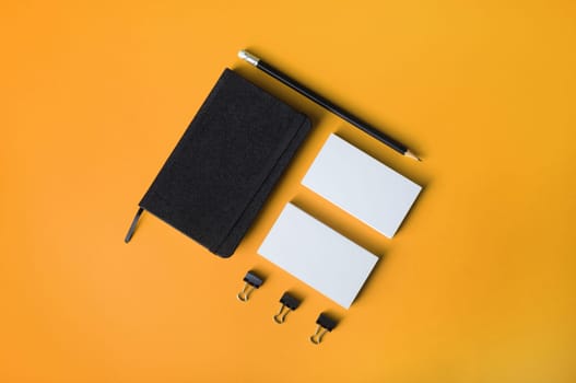 Blank corporate stationery set on yellow background. Template for branding design. Top view. Flat lay.