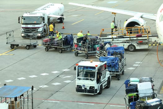 Prague, Czech Republic - July 28th, 2018: Ground personnel loading luggage into Tailwind Boeing 737-400 at Ruzyne, Vaclav Havel Airport.
