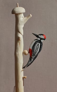 red-headed woodpecker figurine wooden toy close-up