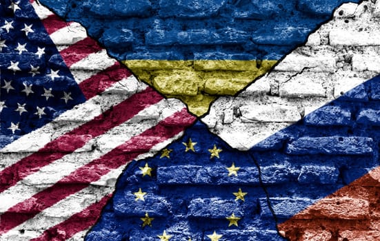 the flags of the USA, Ukraine, Europe and Russia painted on a ruined bricked wall and divided by a crack. International diplomatic relations.