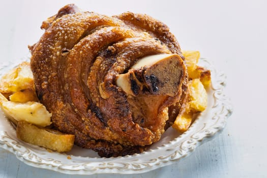 close up of rustic german golden baked pork knuckle