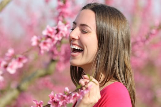 Happy and beautiful woman laughing in a field