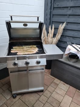Professional chef cooking fish on a barbeque