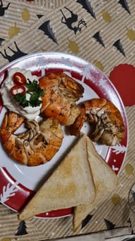 Traditional spanish tapa with prawns cooked in oil with garlic and chili. Served with slice baguette