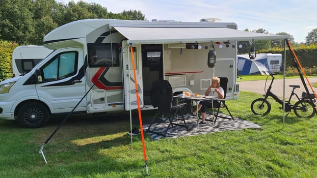 A new mobile home with awning and table and chairs