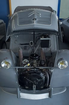 Badajoz, Spain - Feb 10th 2022: 1956 Citroen 2CV, famous 60s all-road economy car. Open hood view