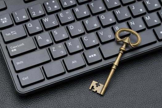 KAGAWA, JAPAN - FEBRUARY 20, 2022 - Old key and computer keyboard. Concept of Internet security, data protection.