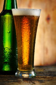 Glass of beer on rustic wooden table