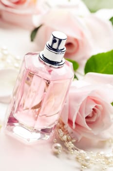 Perfume bottle and roses. Retro style.