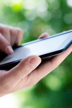 Man holding tablet in the park