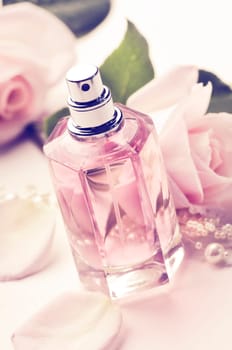 Parfume bottle and roses. Retro style.
