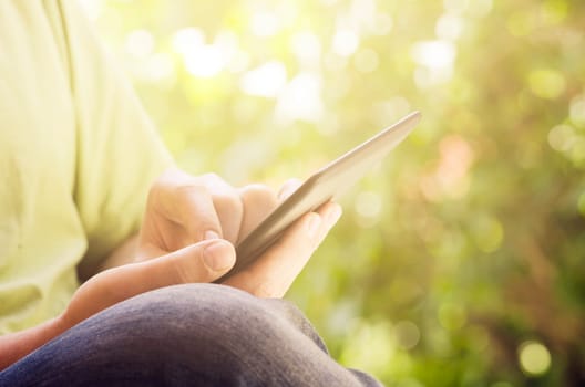 Man holding tablet in the park