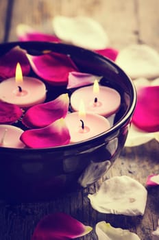 Spa candles and rose petals.